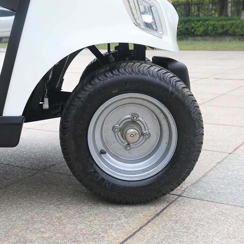 Close view of the 2 seater golf buggy front wheel, showing the turf tyre and steel rim