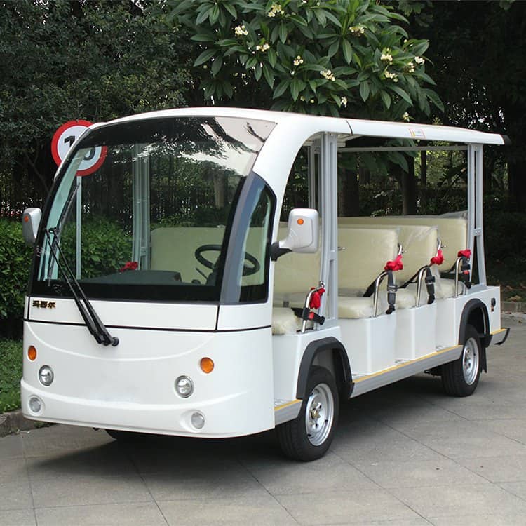 White 11 seat electric shuttle with an enclosed cab and open passenger sides