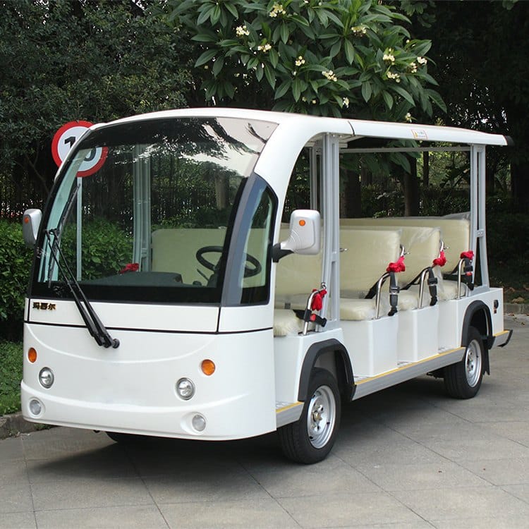 White 11 seat electric shuttle with an enclosed cab and open passenger sides