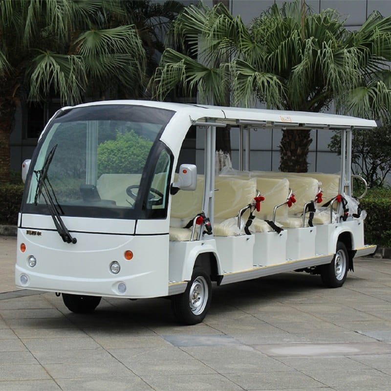 White 17 seat electric shuttle bus with an enclosed cab and a long open body