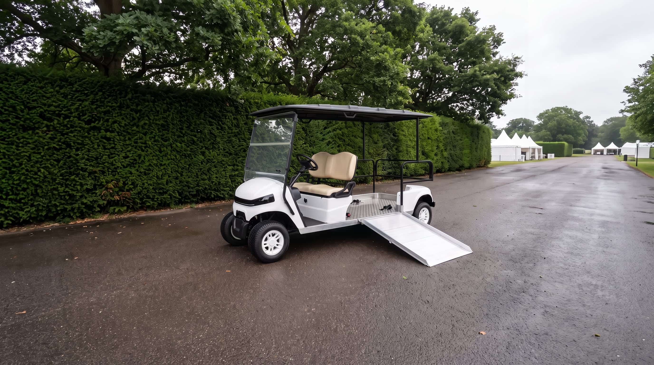 Wheelchair accessible electric buggy with its aluminium side ramp lowered on a tarmac path beside a tall yew hedge at a county showground